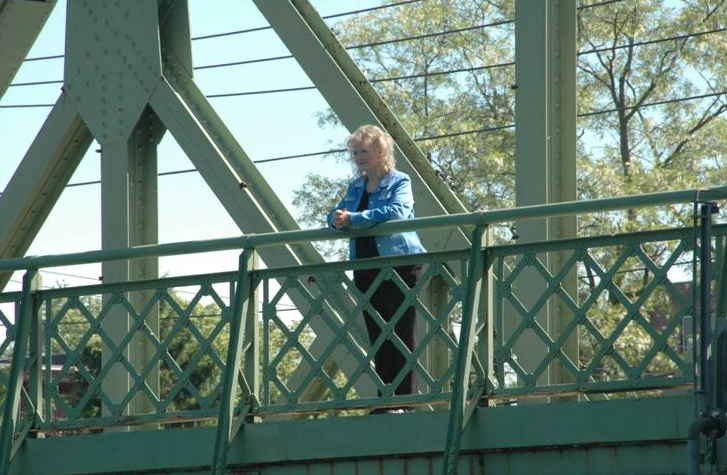 Actor Karolyn Grimes who played Zuzu stands on the bridge.